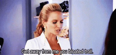 A Woman In A White Suit Is Talking To Another Woman In A Closet And Says Get Away From Me You Bloated Troll . GIF