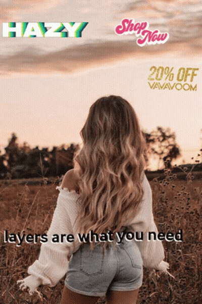 A Woman In A White Sweater And Shorts Is Standing In A Field Of Tall Grass GIF