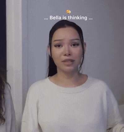 A Woman In A White Sweater With The Words Bella Is Thinking Behind Her GIF