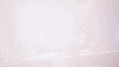 A Woman In A White Swimsuit And Hat Is Sitting In A Pool Of Water GIF