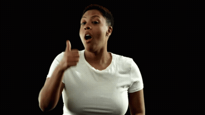 A Woman In A White T-Shirt Giving A Thumbs Up GIF