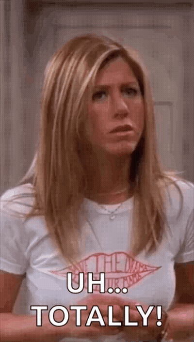 A Woman In A White T-Shirt Is Standing In Front Of A Door And Saying `` Uh ... Totally ! '' GIF