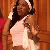 A Woman In A White Tank Top And Headband Is Holding A White Purse And Waving . GIF