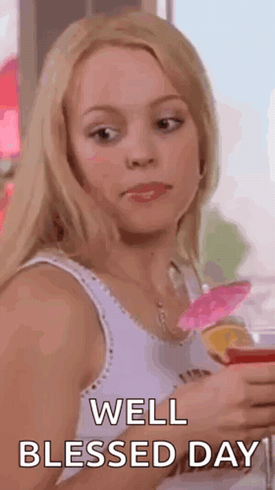 a woman in a white tank top is holding a glass of wine and making a funny face .