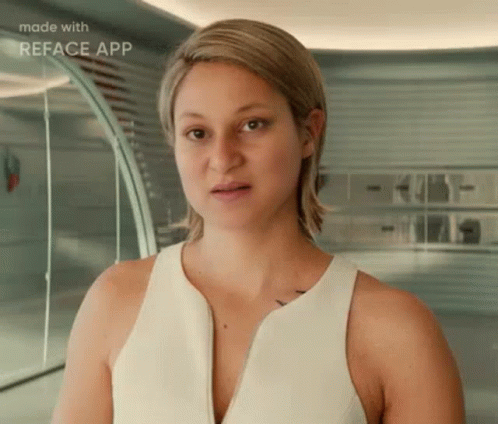 A Woman In A White Tank Top Is Standing In Front Of A Mirror . GIF