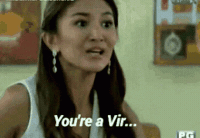 A Woman In A White Tank Top Is Talking To Another Woman And Says `` You 'Re A Vir ... '' . GIF
