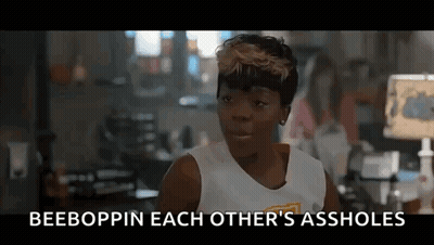 A Woman In A White Tank Top Is Talking To Another Woman In A Room In A Movie . GIF