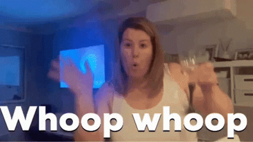 A Woman In A White Tank Top Says Whoop Whoop In A Room GIF