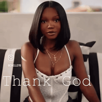 A Woman In A White Top Is Sitting On A Couch And The Words Thank God Are Behind Her GIF