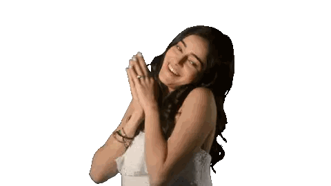 A Woman In A White Top Is Smiling With Her Hands Folded In Front Of Her Face Sticker