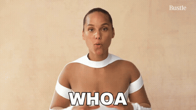 A Woman In A White Top With The Word Whoa On Her Chest GIF