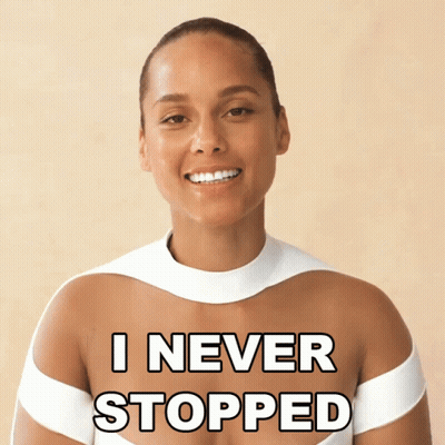 A Woman In A White Top With The Words " I Never Stopped " Written On Her Chest GIF