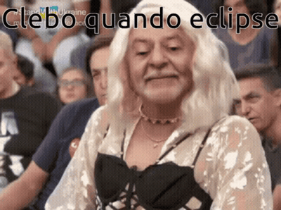A Woman In A White Wig Is Sitting In A Crowd With The Words " Cleboquando Eclipse " Written On The Bottom GIF