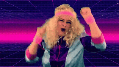 A Woman In A Wig And Headband Is Dancing In Front Of A Grid . GIF