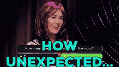 A Woman In A Wig Is Answering A Question About How Many Moons There Are GIF