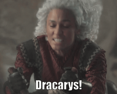 A Woman In A Wig Says " Dracarys " While Holding A Knife GIF