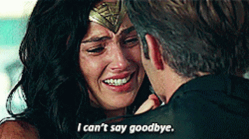 A Woman In A Wonder Woman Costume Is Crying While A Man Holds Her . GIF