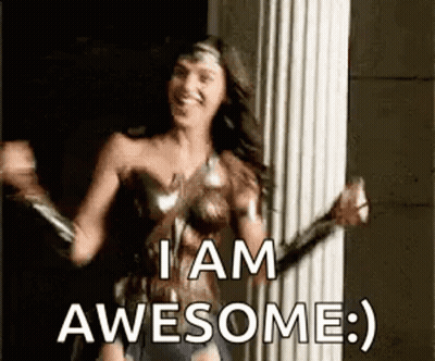 A Woman In A Wonder Woman Costume Is Dancing In Front Of A Pillar And Saying `` I Am Awesome '' . GIF