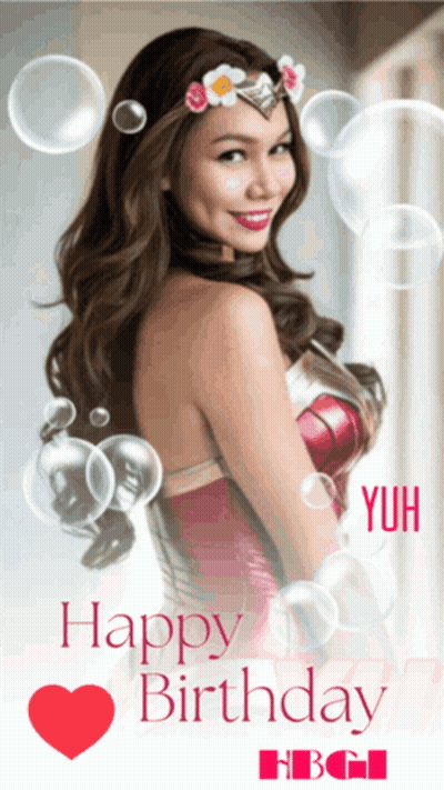 A Woman In A Wonder Woman Costume Is Surrounded By Bubbles And Says Happy Birthday GIF