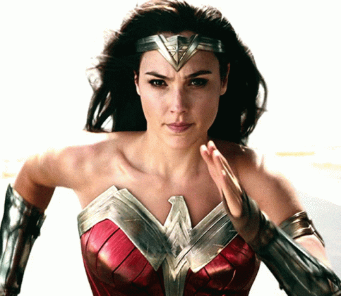 A Woman In A Wonder Woman Costume With A Headband GIF