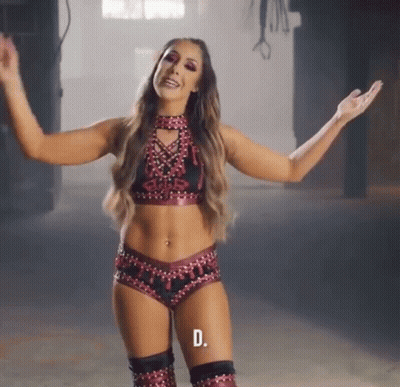 A Woman In A Wrestling Outfit With The Letter D On The Bottom Left GIF
