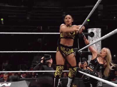 A Woman In A Wrestling Ring Holds A Rope That Says Xo On It GIF