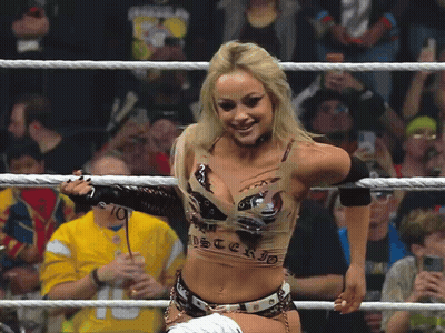 A Woman In A Wrestling Ring Is Wearing A Top That Says Mysterio On It GIF