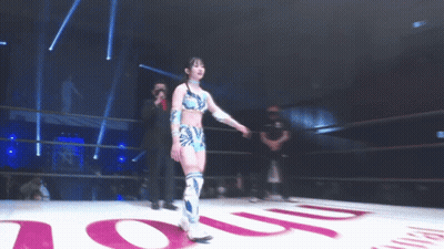 A Woman In A Wrestling Ring Stands In Front Of A Sign That Says ' Oup ' GIF