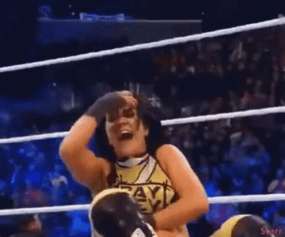 A Woman In A Wrestling Ring Wearing A Shirt That Says Payback On It GIF