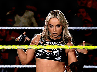 A Woman In A Wrestling Ring Wearing A Top That Says Morgan GIF