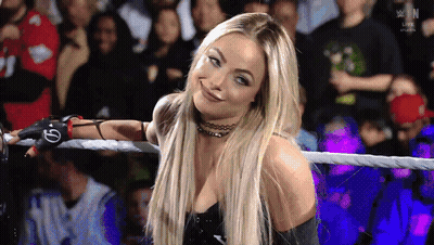 A Woman In A Wrestling Ring With A Glove That Says G On It GIF