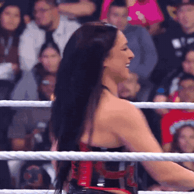 A Woman In A Wrestling Ring With A Rope Around Her Waist That Says ' Tna ' On It GIF