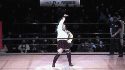 A Woman In A Wrestling Ring With A Sign Above Her That Says 2022.3.19 GIF