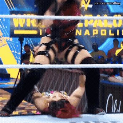 A Woman In A Wrestling Ring With A Sign That Says Napoli GIF