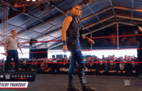 A Woman In A Wrestling Ring With A Sign That Says Network Every Thursday GIF