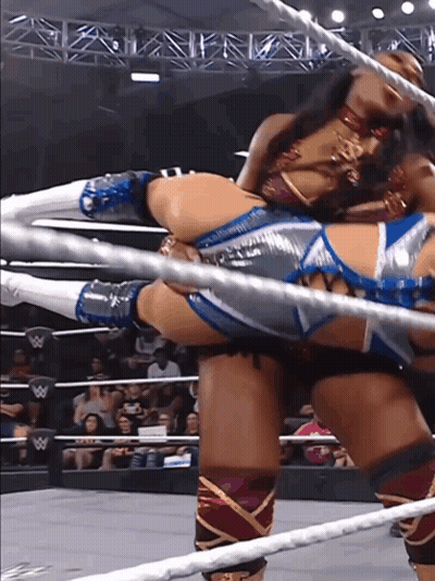 A Woman In A Wrestling Ring With A W Logo On The Ropes GIF