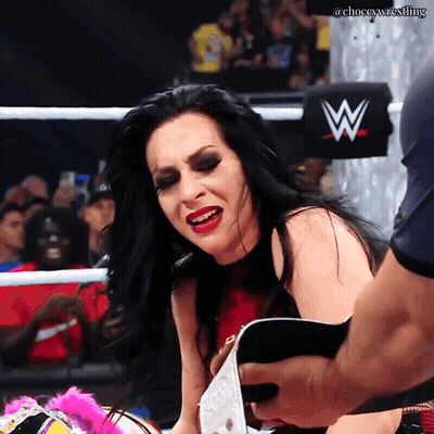 A Woman In A Wrestling Ring With A W On The Back Of Her Shirt GIF
