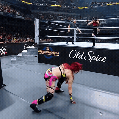 a woman in a wrestling ring with an old spice sign in the background
