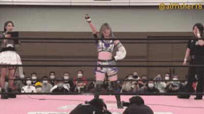 A Woman In A Wrestling Ring With The Number 18 On Her Sleeve GIF