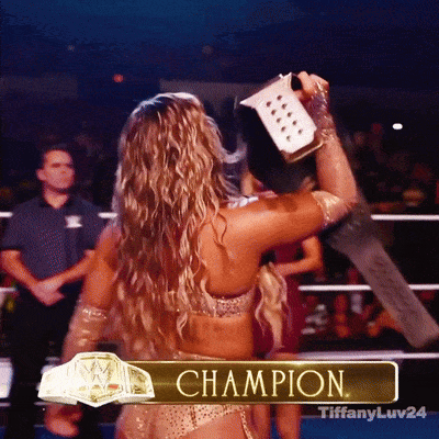 A Woman In A Wrestling Ring With The Word Champion On The Bottom GIF