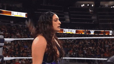 A Woman In A Wrestling Ring With The Word Evolution On The Side GIF