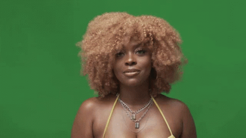 A Woman In A Yellow Bikini And Black Gloves Is Giving A Thumbs Up Sign . GIF