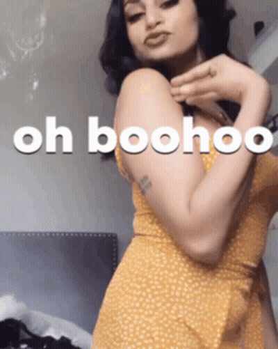 A Woman In A Yellow Dress Has The Words Oh Boohoo Written On Her Arm GIF