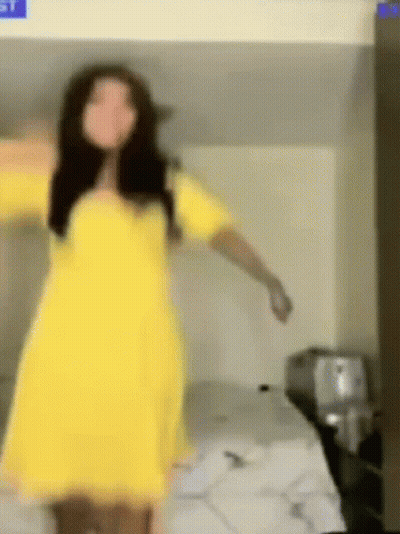 A Woman In A Yellow Dress Is Dancing On A Bunk Bed . GIF