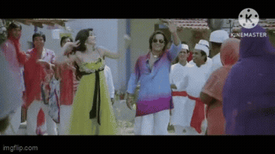 A Woman In A Yellow Dress Is Dancing With A Man In A Blue Shirt In Front Of A Crowd Of People . GIF