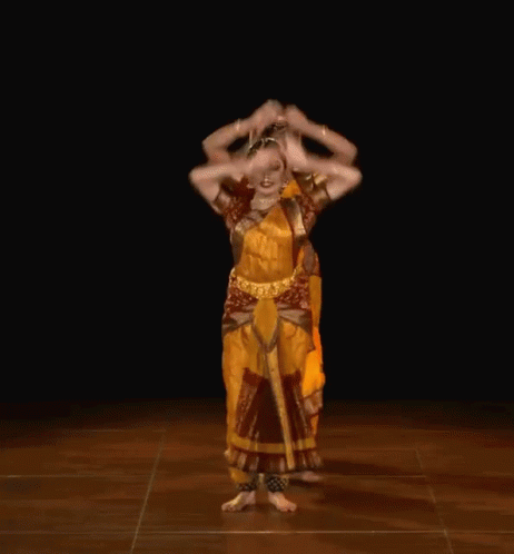 A Woman In A Yellow Dress Is Dancing With Another Woman GIF