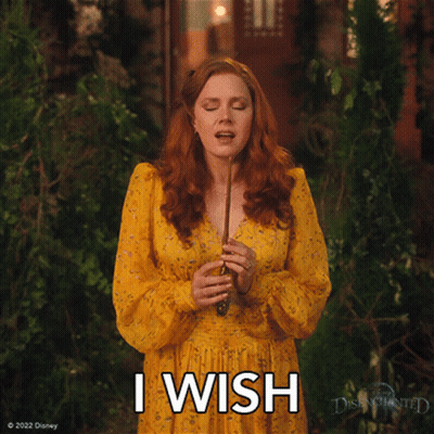 A Woman In A Yellow Dress Is Holding A Wand And The Words I Wish Are Above Her GIF
