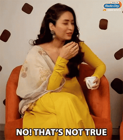 A Woman In A Yellow Dress Is Sitting In An Orange Chair With The Words No That 'S Not True GIF