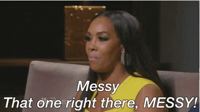 A Woman In A Yellow Dress Is Sitting On A Couch And Says Messy That One Right There Messy . GIF