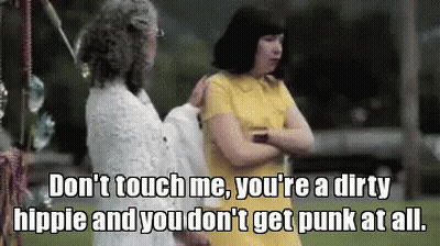 A Woman In A Yellow Dress Is Talking To Another Woman In A White Dress GIF
